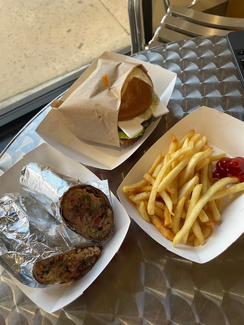 French fries, wrap, and a burger on a table