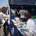 Volunteers interacting with the public in the Vegan Justice booth
